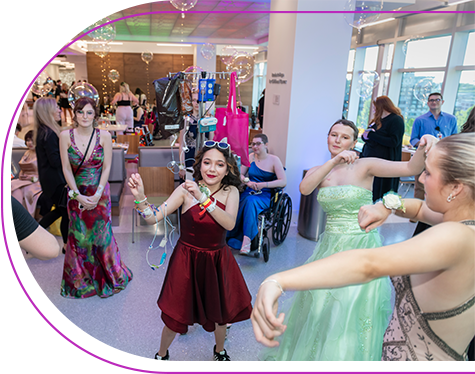 Children's Mercy patients dressed up in prom dresses and dancing at the Patient Prom.