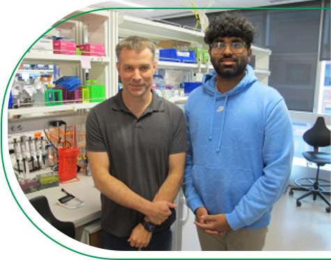 Dr. John Perry standing next to Research Learner Kevin Thomas in the Children’s Mercy Research Institute.