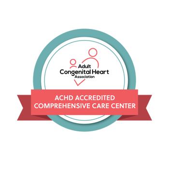 Logo of the Adult Congenital Heart Association featuring a circular badge with a teal and grey border. Inside the circle, there are three red heart-shaped figures connected by two curved lines, symbolizing a network or connection. Above this graphic, the text reads ‘Adult Congenital Heart Association’ in red, and below is a red banner with white text stating ‘ACHD ACCREDITED COMPREHENSIVE CARE CENTER.’ The overall design conveys medical professionalism and accreditation in the field of adult congenital heart care.