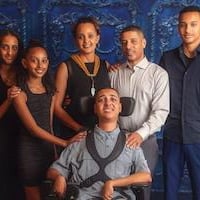 Rahel Kebede with family with navy blue backdrop 