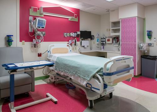 View of empty inpatient room that includes patient bed, seating for visitors at Adele Hall location of children's Mercy. 