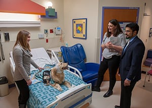 The doctor visits Hope in the EMU at Children's Mercy during testing.