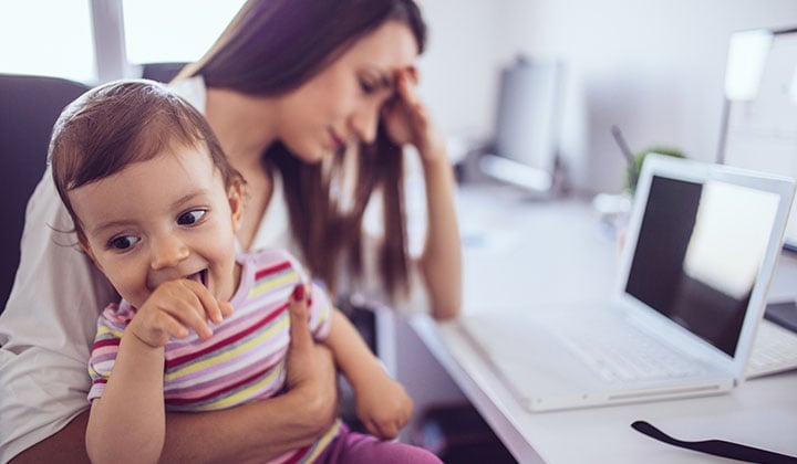 Frustrated mom holding child